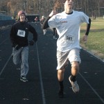 Junior Robby DeYoung and Junior Dominic Chichateli runs with enthusiasm to finish the last leg off the race.