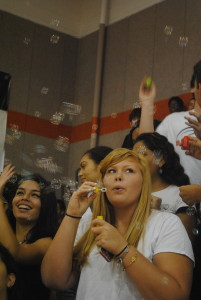 Senior Courtney Herzog blows bubbles during the pep rally. 