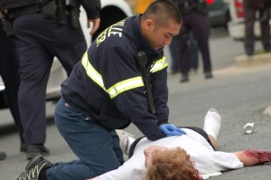 EMT worker Alex Sha attempts to perform CPR on the injuried pedestrian.