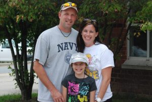 Physical education teacher Frank Weaver poses with his wife and daughter Lily, the namesake of Lily's Hope, which students and staff have contributed to. --Photo by Sontanna Cremins