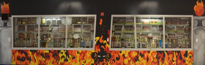 New student mural portrays the flames that burn bright in RHS' Inferno. The design was meant to add some color to the once white wall with images of flames and pillars to give the feeling that as people enter the gym, they enter "The Inferno."