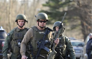 FBI SWAT team members walk along Dickinson Drive near Sandy Hook Elementary School in Newtown, Connecticut, Friday, December 14, 2012. Twenty-seven people, including 18 children, have been killed in a shooting at Sandy Hook Elementary School. Courtesy of MCT Campus