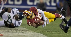 Washington Redskins quarterback Robert Griffin III dives for a first down in the first half against Seattle Seahawks during the first round of the NFC wild-card playoff game at FedEx Field in Landover, Maryland, Sunday, January 6, 2013. Courtesy of MCT Campus