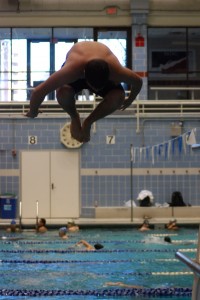 Sophomore Joey Lynch dives into the water at Kennedy Aquatic Center during practice. The team meets every Saturday and Monday while in-season. --Thomas Sheil
