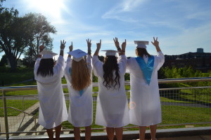 Heavenly Williams, Torey Vayer, Adrienne Tantardini and Tess Garraty look off into the distance while holding up a one and three to represent the year they are graduating. --Camila Torres