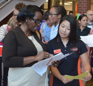 Sophomore ambassador Katrina Le helps parents find their assigned classrooms according to their childrens' schedule during Back to School Night on Aug. 29. --Adam Bensimhon