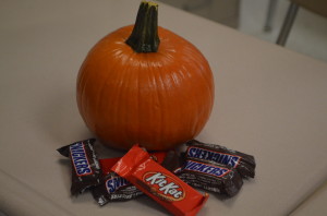 A teacher's desk is showing of the Halloween spirit, affixed with pumpkins and candy. --Elissa Britt