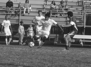 Junior Anibal Saenz Jr. kicks the ball past an opposing player during the Rams 2-0 victory over the Seneca Valley Screaming Eagles on Sept. 26. The Rams earned their first victory in two seasons in a impressive defensive and offensive showing. --Adam Bensimhon