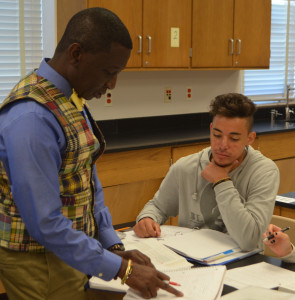 Girardi works diligently in his physics class with his science teacher George Bonney. --Adam Bensimhon