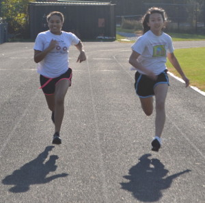 Sophomores Brianna Anthony and Emily Gee run along the track at off-season girls' basketball workouts in order stay in shape and prepare for upcoming tryouts starting Nov. 15.