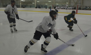 Freshman defenseman Koby Kovacs pushes the puck up the ice in the team's season opening 10-0 victory over Damascus HS Nov. 15. Kovacs is a young player who looks to lead the team in the future. --Adam Bensimhon