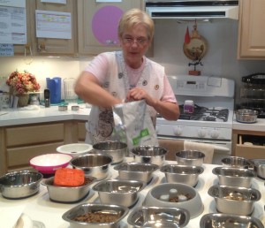 Sher Polvinale fixes dinner for the House With A Heart residents. She begins to fix dinner in the early afternoon because many of the dogs have special dietary needs that require different types of food. Sher Polvinale fixes dinner for the House With A Heart residents. She begins to fix dinner in the early afternoon because many of the dogs have special dietary needs that require different types of food. --Katie Aceto