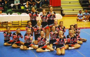 The Cheerleading team shows the motions of their routine at their compeition on Nov 6. The team placed fifth place out of eight other teams in Division III. Courtesy of Dorinda Hailstock