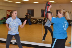 Freshman Hannah Sarsony prepares to defend herself from an incoming attack. Students and even alumni showed up to class in order to prepare themselves against potential attacks. Participants got the chance to test their techniques against trained instructors. --Meklit Bekele