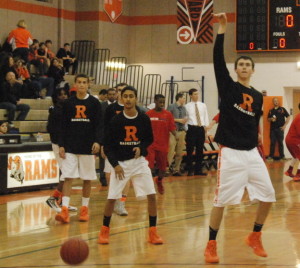 Junior Kellen Cremins sinks a shot as the varsity boys' basketball team warms up for a game against Wootton HS. The boys won the game by three points. --Mara Monroe