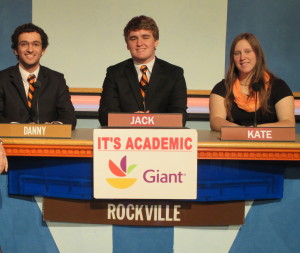 Seniors Danny Hoffman, captain Jack Berrigan and Kate Lipman compete at the podium during their quarterfinals in the It's Academic Playoffs Feb. 18. Competitions include trivia from many subjects. --Courtesy of It's Academic