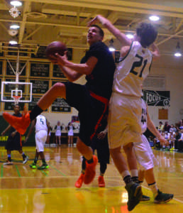 Senior guard Brian Ball drives to the basket against a Damascus defender Feb 20. Ball, a captain of the team, had 11 points and six rebounds. --Adam Bensimhon