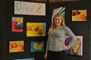 Senior Olga Zhigunova poses in front of a collection of her artwork.Zhigunova was awarded with a Scholastic Art & Writing Gold Key. --Mercy Fosah