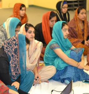 Junior Gujri Chadha (center) and alumna Amreen Chadha (2012) listen to