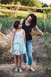 Counselor and cookbook author Wendy Kiang-Spray shown in her garden with daughter Lyric. Photo Courtesy of Sarah Culver