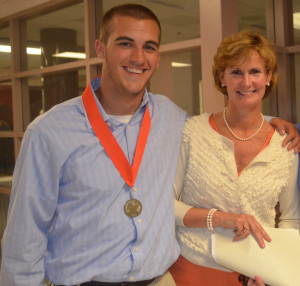 Principal Billie-Jean Bensen poses with alumnus Tyler Reed (2014) after this year's Senior Awards Ceremony May 22. Bensen was the second principal for the class of 2014. --Camila Torres