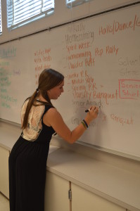 Senior Lauren Goldstein helps organize future school functions by writing the events that need to be planned. --Mercy Fosah