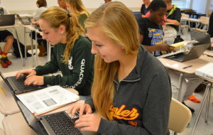 Senior Anna Walker (front) and junior Erin Moriarty (back) use the Chromebooks in their AP Psychology class with teacher Christine Zafonte. They used the laptops to finish an assignment. --Mercy Fosah