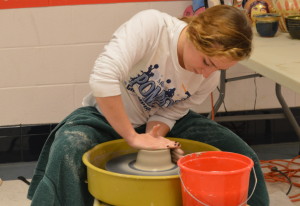 After centering her clay, junior Erin Moriarty crafts her bowl on the potter's wheel during Art Blitz Week. The event ran from Jan. 26 to Jan. 30 in the arts hallway to help recruit students for art classes. --Elissa Britt