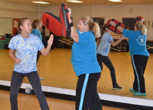 Sophomore Hannah Sarsony practices an attack with a professional trainer in a women's self defense class that was offered at RHS to women over 14 by Rape Agression Defense systems. --Meklit Bekele