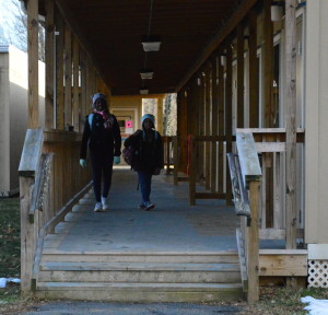 Barnsley Elementary School students Cyan and Circe Joseph walk from the portables. Due to an increasing student population, many classes need to bundle up in order to endure the cold. -Mercy Fosah