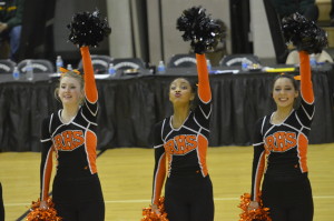 Senior captain Madison Cary (left) along with juniors Ambre Flowers (middle) and Cristina Granados (right) perform during the county invitational at Northwest HS Jan. 21. The poms placed sixth, but are practicing a new routine to perform at county competitions. --Meklit Bekele