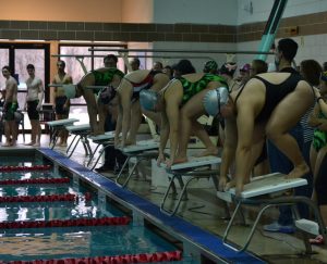 RHS and Kennedy HS swimmers take their mark as they prepare to race. The girls swim team has been facing challenges with participation this season, but still push through. --Elissa Britt