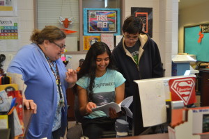 From left: Media Specialist Sherry Weiss talks to student aides senior Lisa Da��Souza and junior Avery Eng. IMC hours will be cut due to budget shortages. --Camila Torres