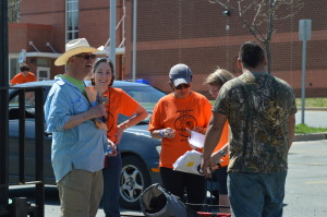 Scott Smith collaborates with some of the other adults helping him with the mulch sale. They not only work together but also have fun as well.