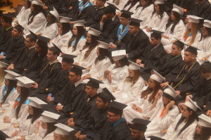 The class of 2014 patiently awaits their time to turn the tassel. The coordinated color of robes may be visually appealing, but it imposes expensive clothes restriction on students. --Camilla Torres