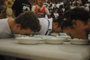 Students participate in a pie eating contest during the pep rally.