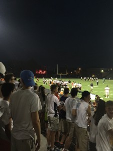 The white hot inferno student section looks towards the scoreboard, reading 26-7, Rockville, with three minutes left before half-time.