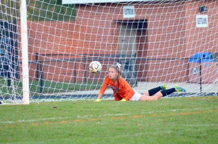 Junior Hannah Sarsony dives to prevent the ball from reaching the goal