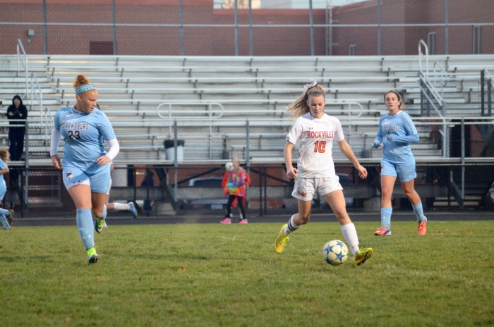 Junior Allison DiFonzo dribbles the ball away from the Clarksburg players.