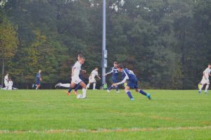 Senior Carlos Piedrasanta prepares to kick the ball past the Magruder players.