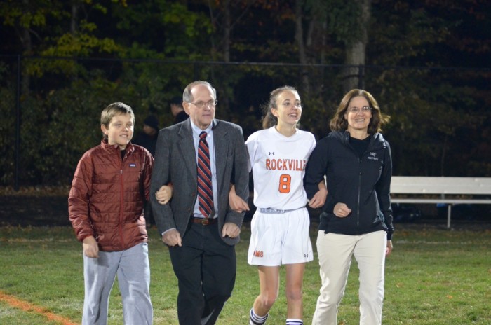 Weiler walks the field with her family during the senior night event between the girls and boys games.
