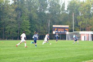 Players from Rockville and Magruder eagerly run for the ball.