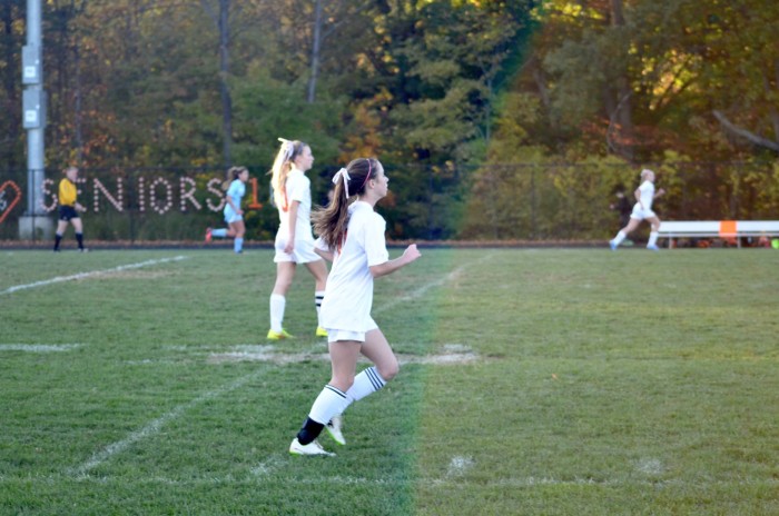 Freshman Charlotte Davis runs across the field.