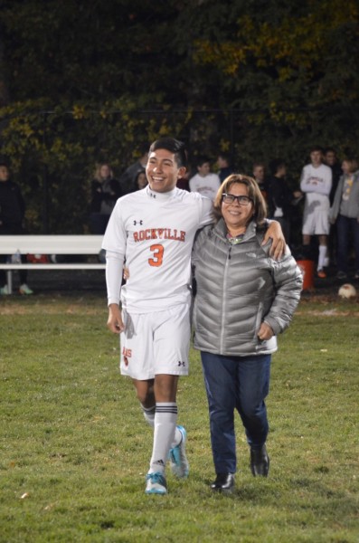 Senior Steve Cevallos walks the field with his mother.
