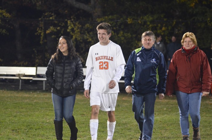 Senior Conor McGinley walks across the field with friends and family.