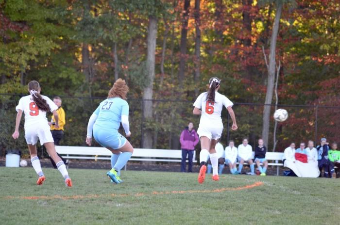 Junior Danielle Dean and Giron runs around the field.