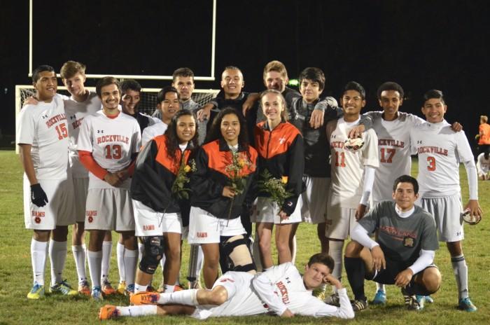 Seniors from the girls and boys varsity teams pose together for a picture.