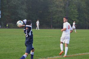 Senior Lucas Lima runs towards the direction of the ball being thrown by a Magruder player.