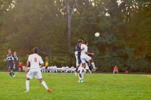 Lima watches as Piedrasanta collides with other players as they jump for the ball.