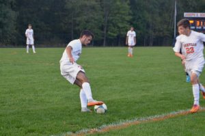 Lima dribbles the ball away from the sideline.